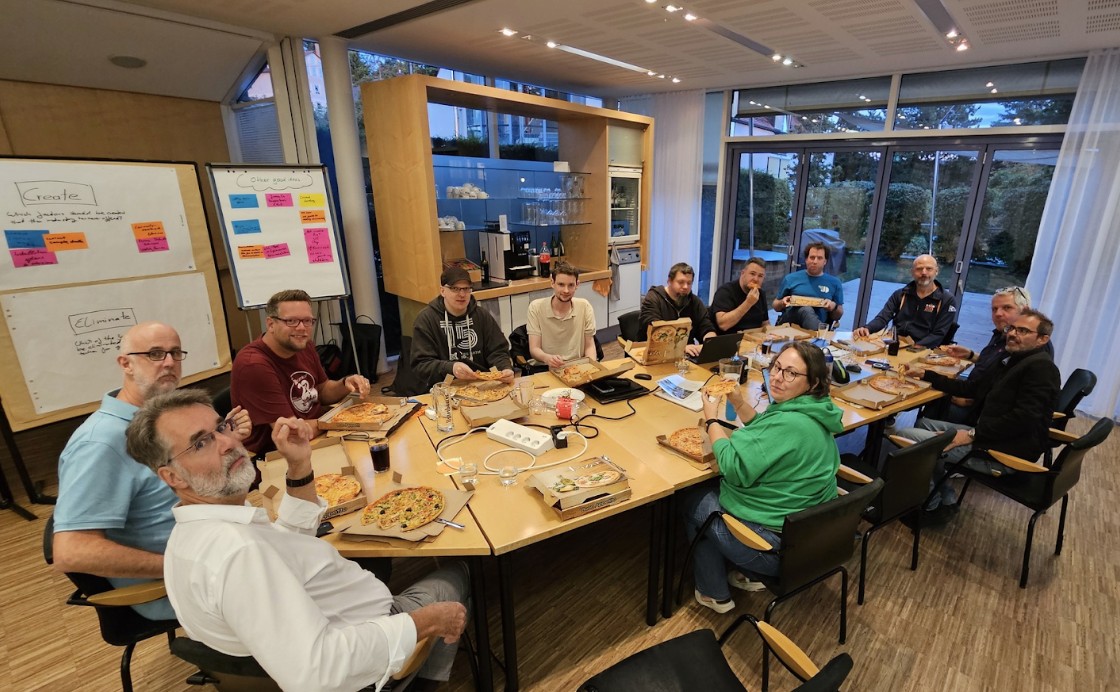 all participants at table with pizza